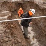 students hard at work in a deep trench